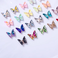 Macro detail of colorful 3D crystal butterfly nail art charms with micro metal setting