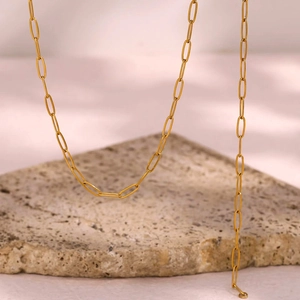 Detail of 18K gold plated stainless steel paperclip chain necklace on stone base