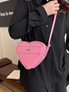 Pink heart-shaped crossbody bag made of premium PU leather with silver metal zippers