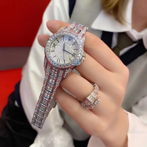 Close-up of luxury silver SCOTTIE watch with crystal dial and matching rhinestone ring