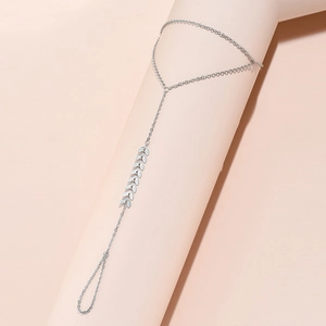 Close-up of silver finger ring bracelet with delicate leaf-shaped chain links