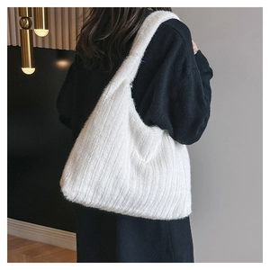 Detail of soft white faux fur tote bag showing plush texture and wide shoulder strap