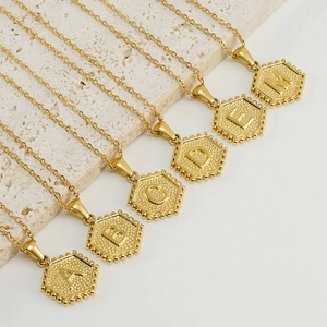 Golden hexagon letter pendants in A, B, C, D, E, M on fine stainless steel chains
