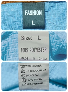 Détail des étiquettes montrant la taille L et la composition 100% polyester du tissu