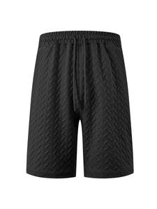 Close-up of black drawstring shorts featuring textured jacquard quilting and soft fabric