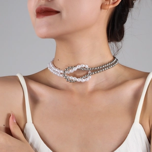 Close-up of double-layer necklace with white pearls and silver beaded chain detail