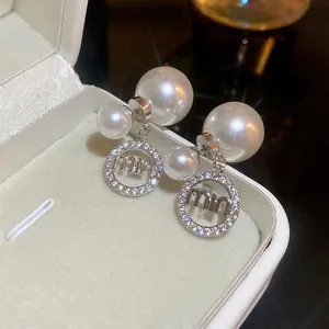 Elegant silver needle double pearl earrings with zircon logo pendant on jewelry box