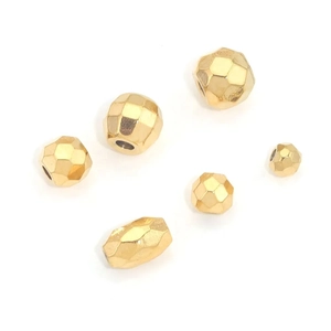 Faceted golden stainless steel spacer beads for DIY jewelry making on white background
