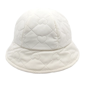 Detailed view of heart-shaped quilting and stitching on a beige corduroy bucket hat