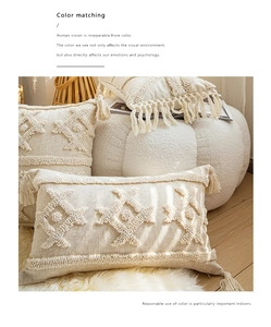 Detail of bohemian cream tufted cushion covers with handmade tassels and geometric texture