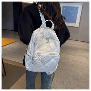 Detail eines weißen Stepprucksacks mit holografischem Finish und Metalltextur