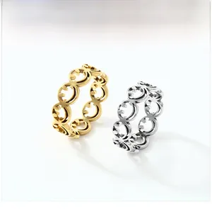 Detailed view of hollow smiley face cutout patterns on gold and silver steel rings