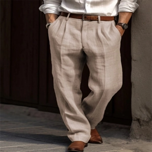 Detail of beige linen trousers with pleated front and brown leather belt for men