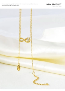 Macro shot of gold infinity symbol pendant with zircon on premium titanium steel necklace