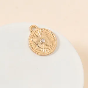 Macro shot of gold plated butterfly pendant with center crystal for jewelry making