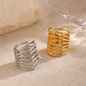 Stacked 18K gold and silver layered rings with textured hammered finish on stone