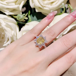Exquisite sunflower yellow zircon ring with silver floral pavé diamonds on finger