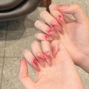 Handmade blood red marble press-on nails in almond shape with 3D crystal accents