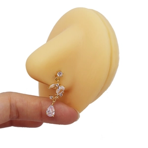 Golden heart zircon nose stud chain with dangling teardrop pendant on a silicone model