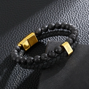 Detail of double-layer men's leather bracelet with volcanic stone and gold steel clasp