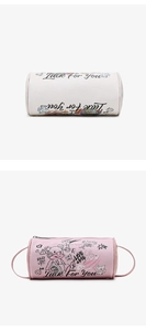 Detail of cylinder pouch showing leather texture and colorful cartoon graffiti prints