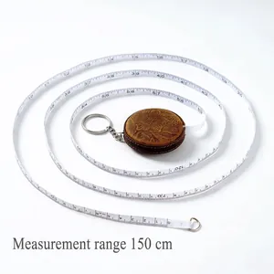 Vintage brown leather retractable tape measure with embossed floral pattern for sewing