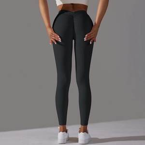 Detail of black scrunch butt yoga pants highlighting back shaping and lifting texture