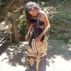 Detail of tropical palm leaf print maxi dress with waist cut-out and beaded details