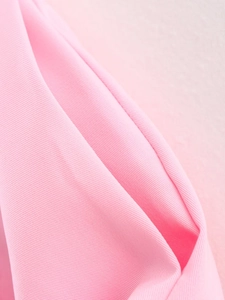 Macro shot of pink twill fabric texture showing detailed weave for women's casual set