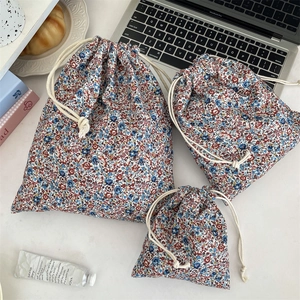 Detailed set of three floral drawstring storage bags in various sizes for travel