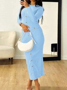 Detail of blue knit dress with single-breasted design and elegant tweed-like texture