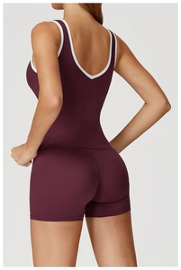 Close-up back view of burgundy sports set with white piping and elastic fabric