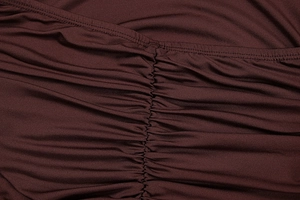 Detail of ruched center seam and fine stitching on a burgundy knit summer dress