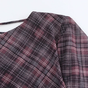 Detail of the dark purple plaid mesh fabric showing fine straps and neckline texture