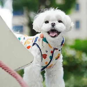 Close-up of a cartoon print dog vest with colorful patterns and metallic snap buttons
