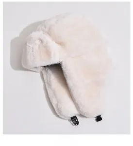 Detailed view of plush faux fur trapper hat with soft texture and earflap buckle strap