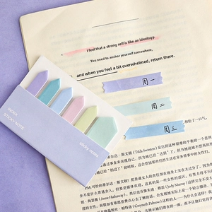 Close-up of arrow-shaped gradient sticky notes in macaron colors on an open magazine