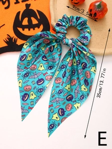 Detail of Halloween bow hair tie with pumpkin ghost print and 35cm ribbon length