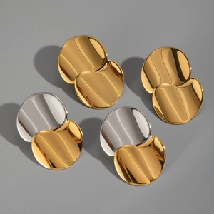 Detail view of geometric round earrings in gold and silver mirror finish stainless steel