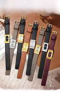 Close-up of elegant vintage square quartz watches with leather straps on musical background