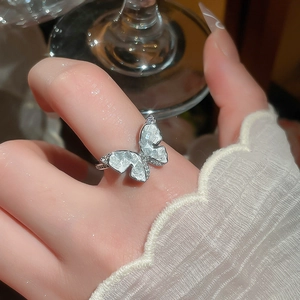 Macro shot of 14k gold plated butterfly ring with sparkling zircon stones and white petals