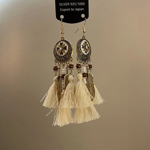 Vintage bohemian tassel earrings with floral metal base and delicate feather pendants