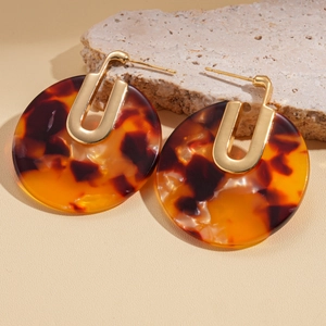Detail of tortoiseshell resin circular earrings with 18K gold plated metal connector
