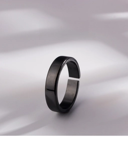 Macro shot of minimalist black matte adjustable ring with a brushed metal texture finish