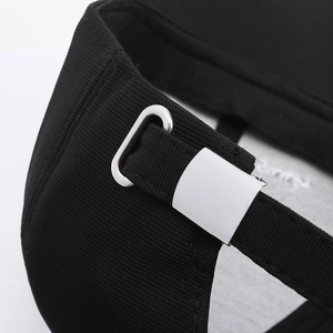 Close-up of black baseball cap with adjustable silver metal buckle and fabric strap