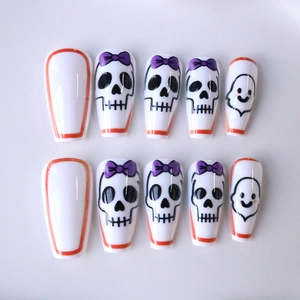 Halloween coffin press-on nails with skull, purple bow, and ghost patterns on white base