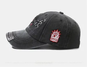 Detail view of New York embroidered baseball cap with leather trim and washed texture