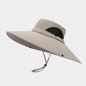 Detail view of khaki bucket hat featuring wide sun brim and breathable side mesh panels