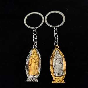 Close-up of religious Our Lady of Guadalupe metal keychains in gold and silver finish