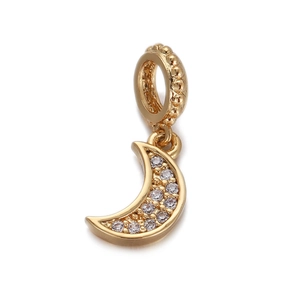 Macro shot of gold moon pendant with sparkling zircon inlays and textured loop bail